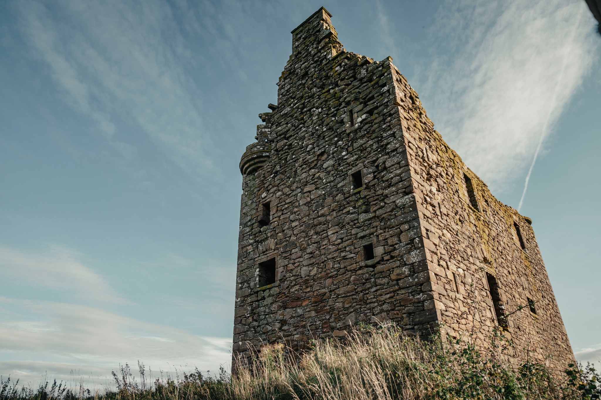 Baltersan Castle seen from a low angle against an open Scottish sky